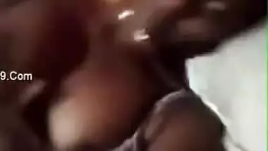 Tanned Desi girl lies in bed stripping XXX boobies for old pervert