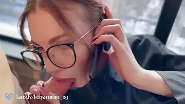 Hot slut talking on the phone with her husband while her friend fucks her.